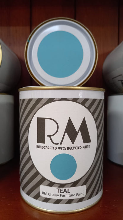 Can of RM teal chalky furniture paint with lid open on a wooden surface