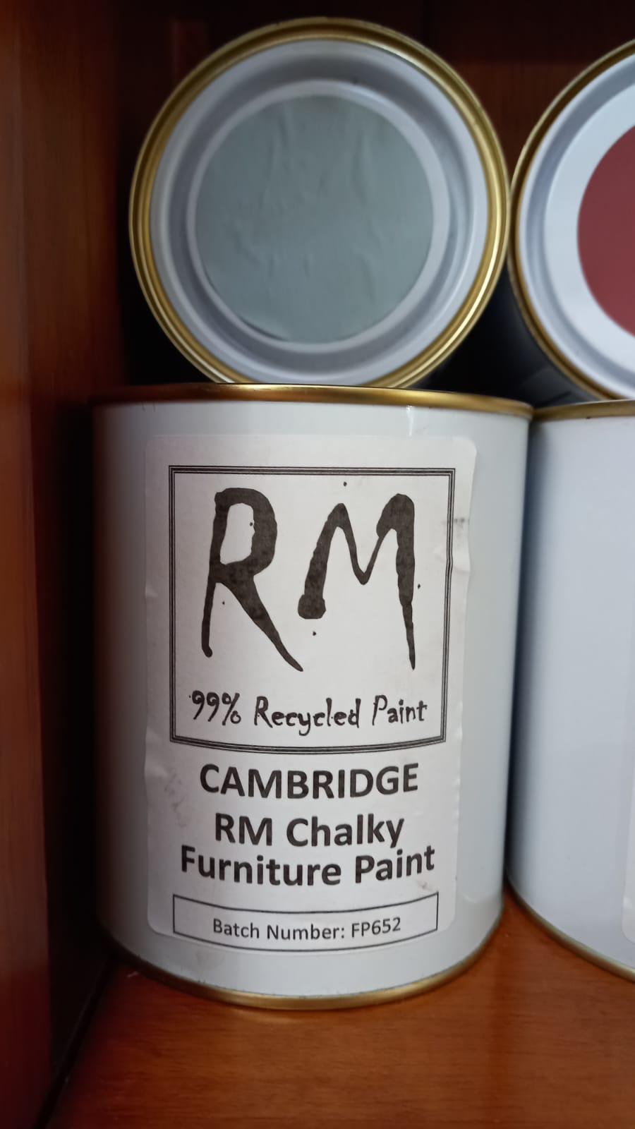 Can of Cambridge RM Chalky Furniture Paint with 'RM' branding on a wooden surface.
