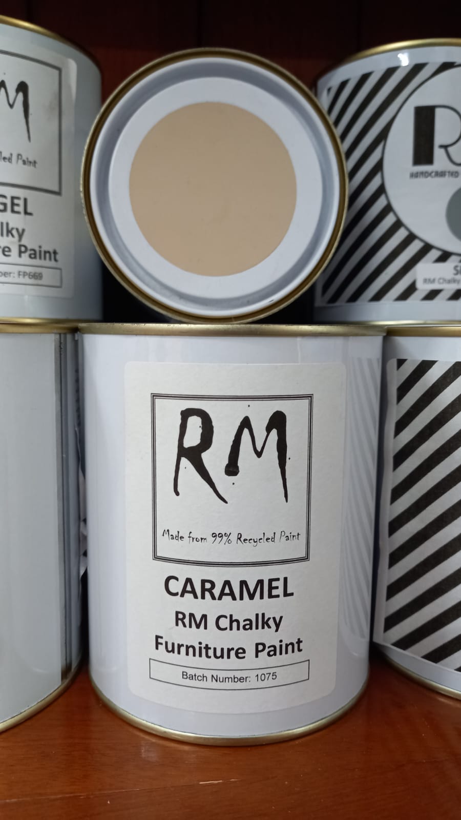 Can of RM Chalky Furniture Paint in Caramel color on a wooden surface